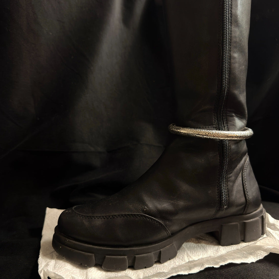 Engraved oxidized brass boot cuff worn on black boot