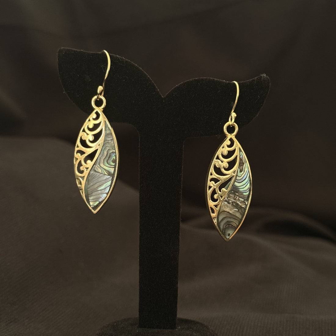 Long leaf shaped brass earrings split between filigree and abalone shell