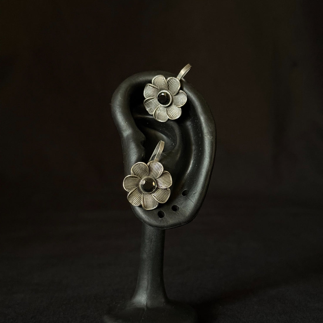 Oxidized brass flower ear cuffs with black stone centers