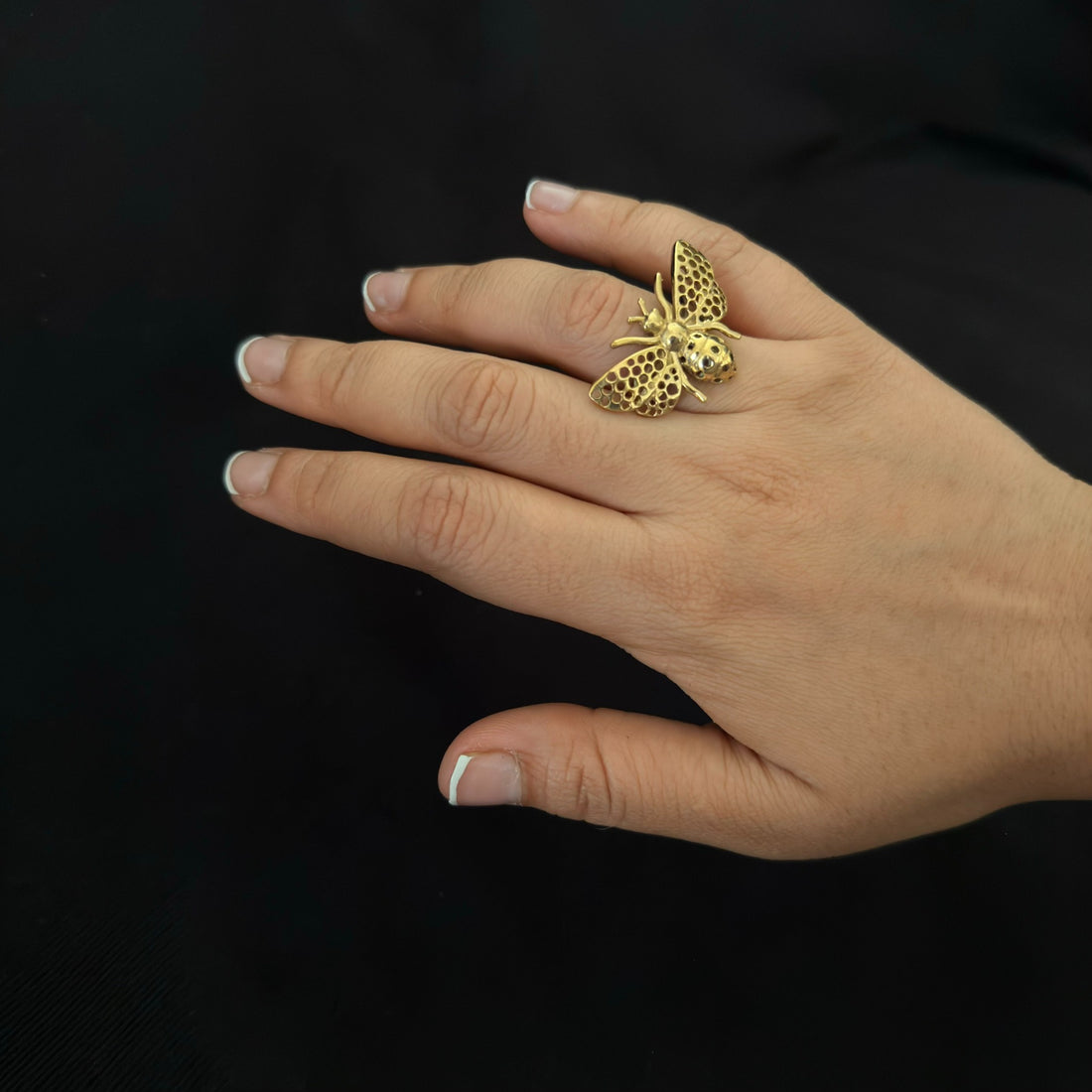 Brass honeybee statement ring worn on hand