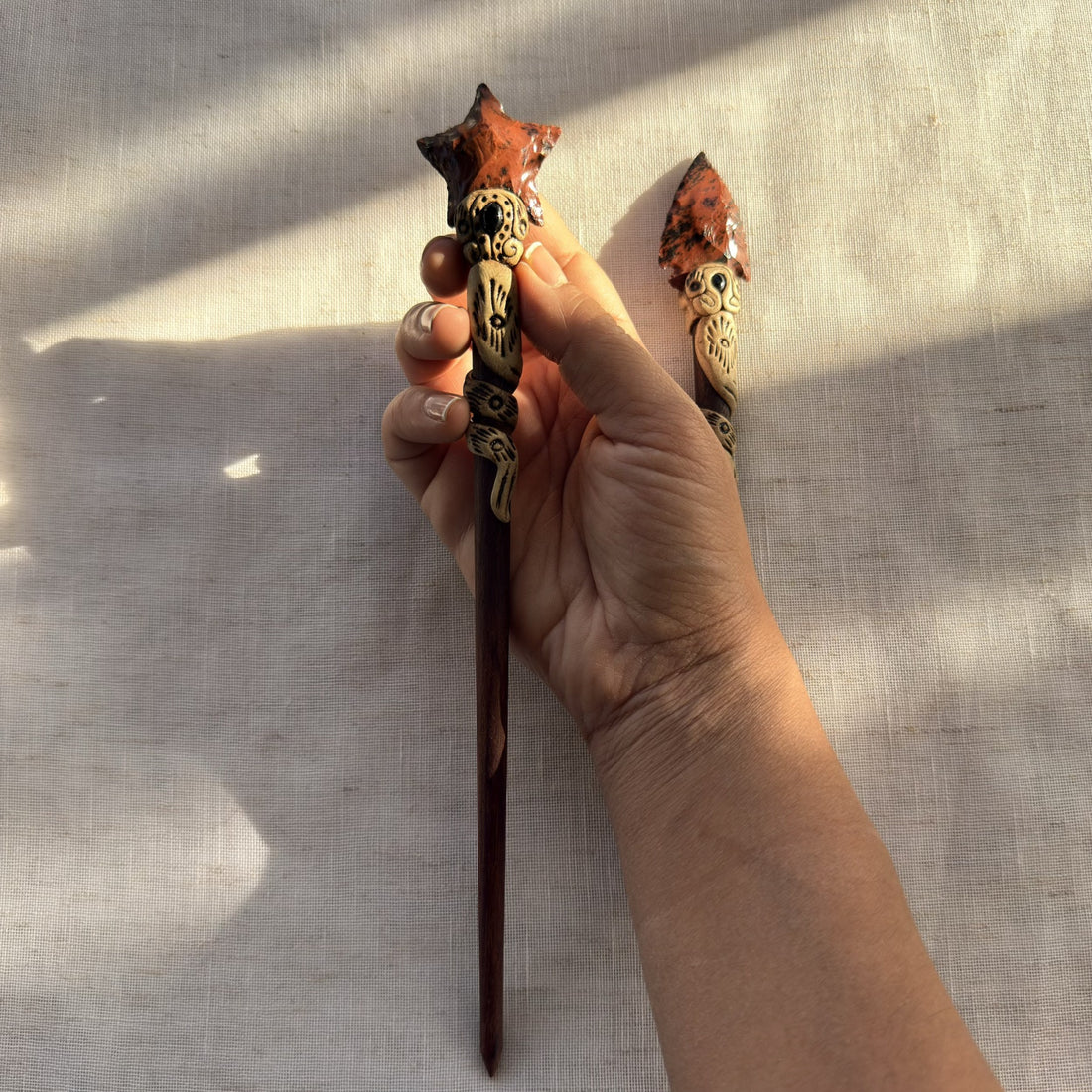 Orange glass arrow hair stick detail