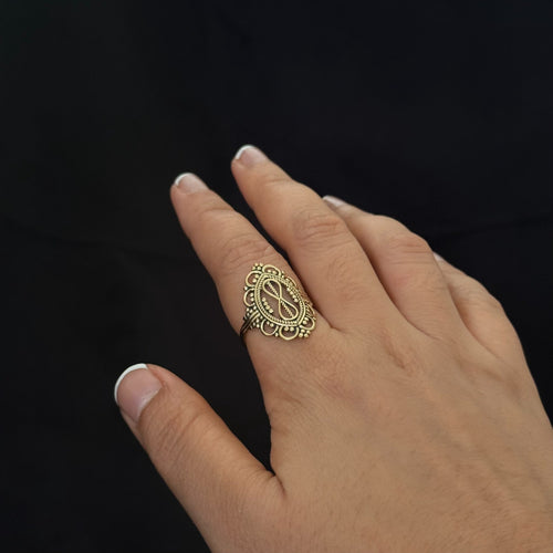 Ornate infinity statement ring in warm gold tone