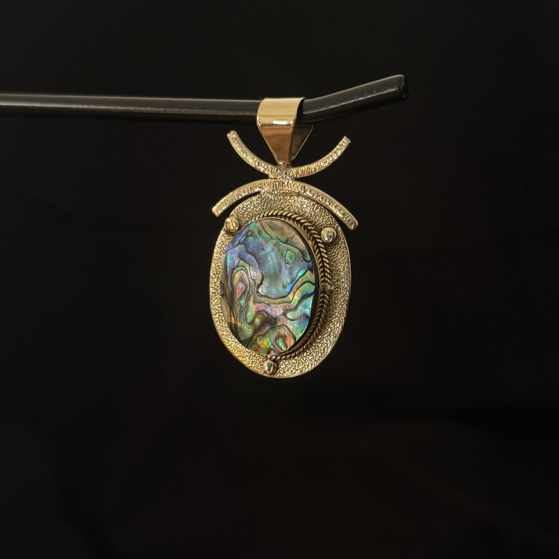 Large brass statement pendant with oval iridescent abalone shell