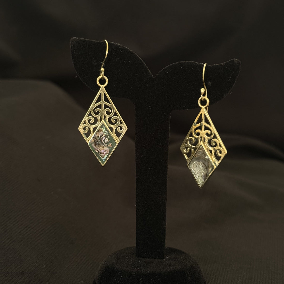 Diamond shaped brass earrings with scrollwork and abalone shell