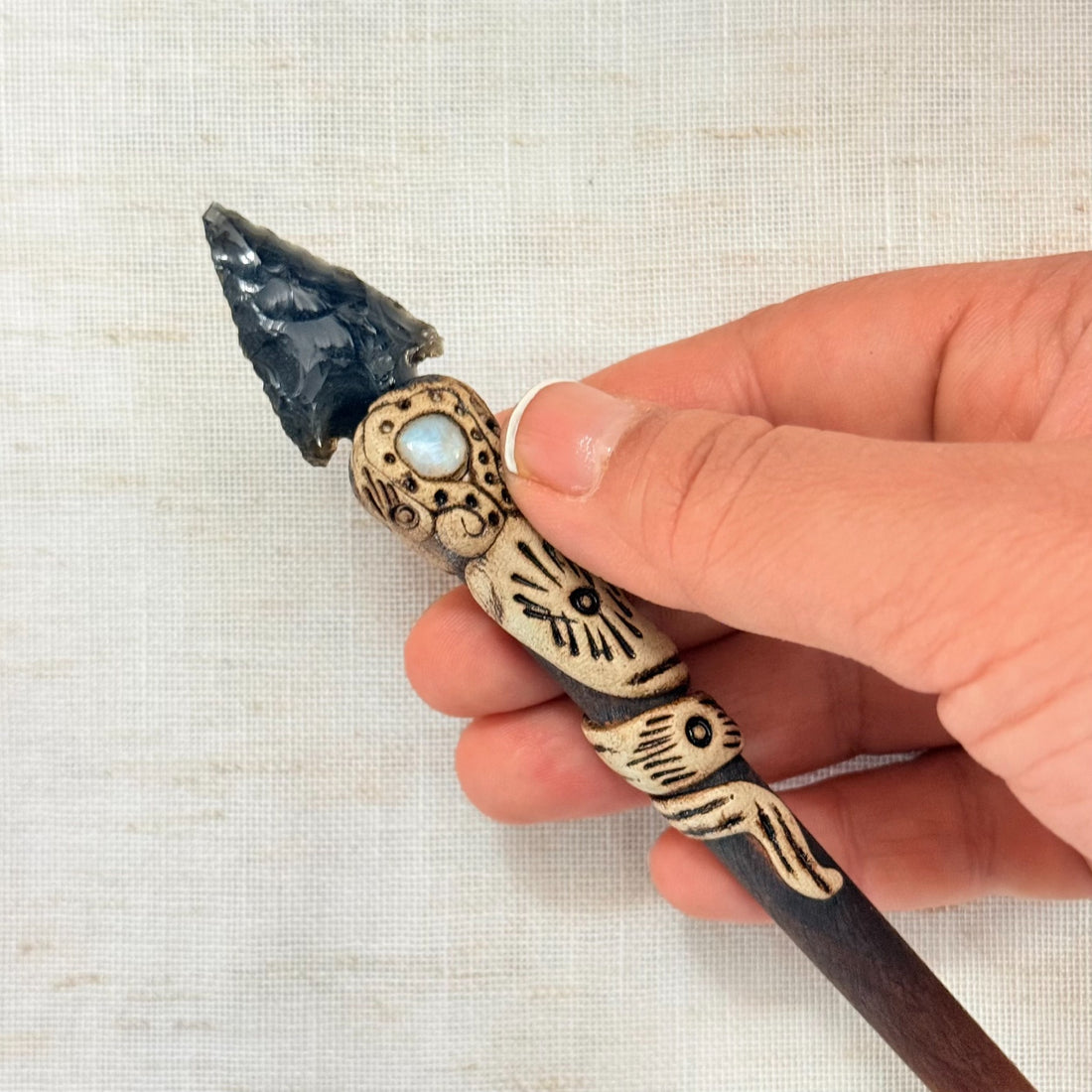Handmade black obsidian arrow hair stick with pale accent stone