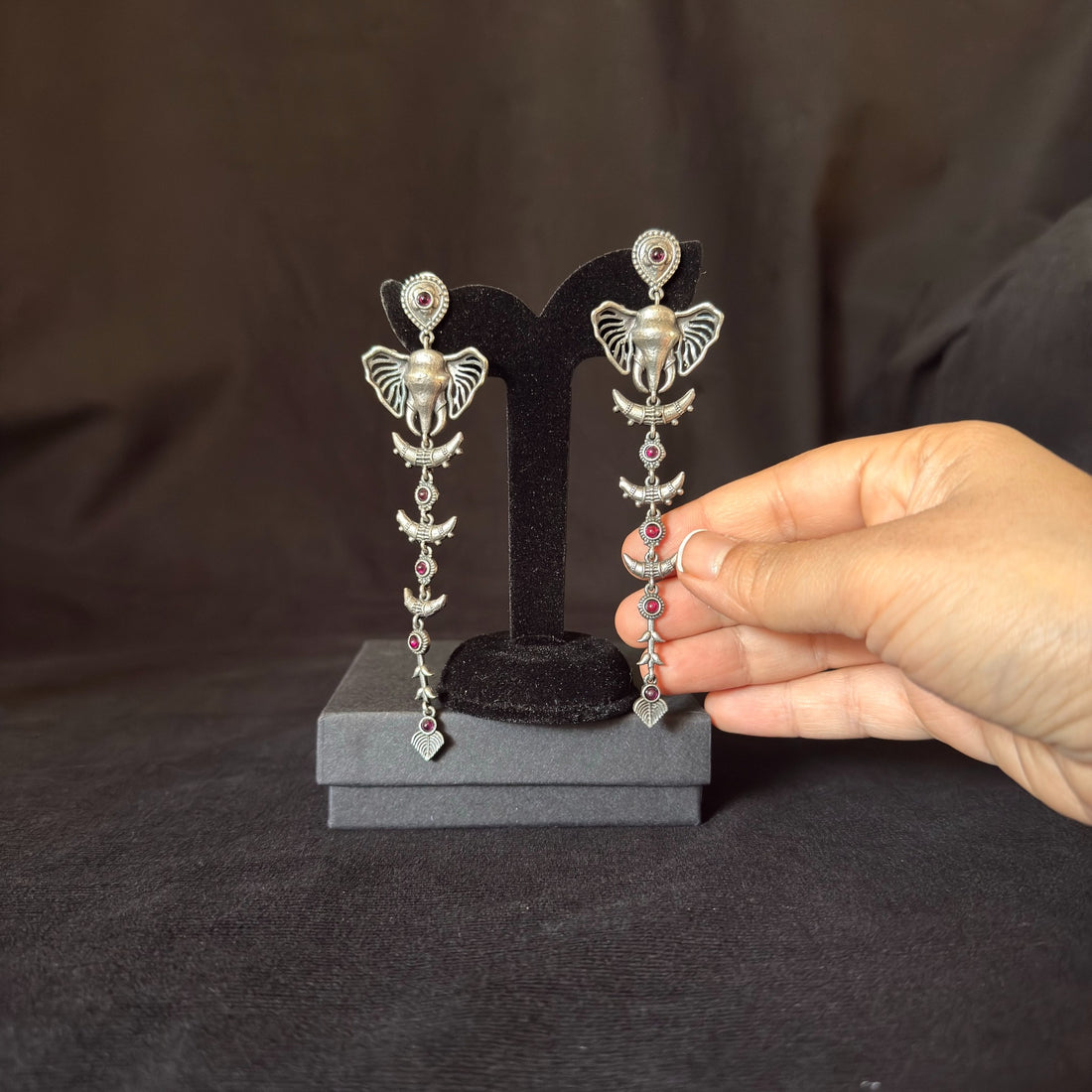 Oxidized brass elephant chain drop earrings with red stone accents