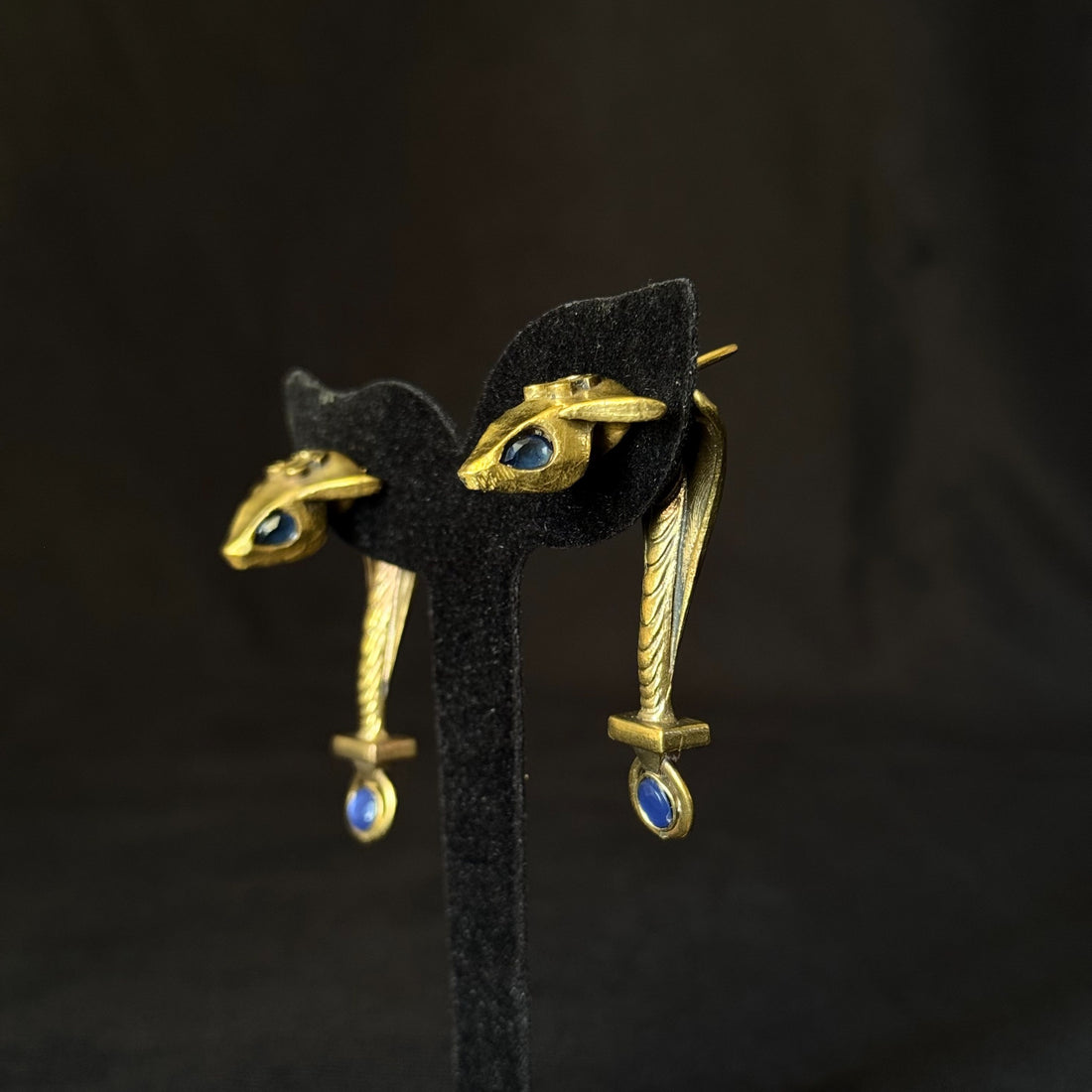 Antique gold brass eye earrings with blue stone accents