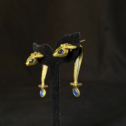 Antique gold brass eye earrings with blue stone accents