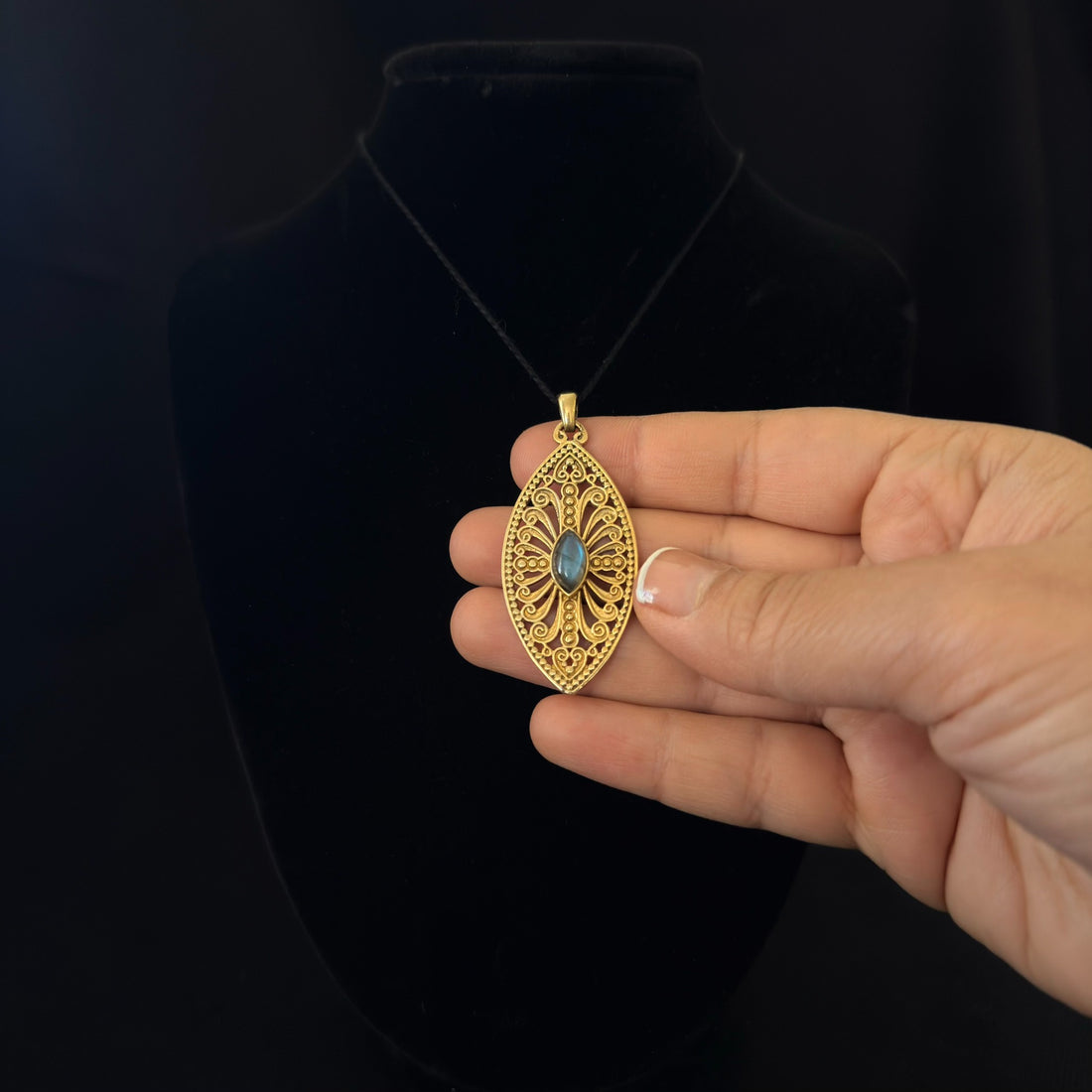 Filigree pendant with blue-gray stone
